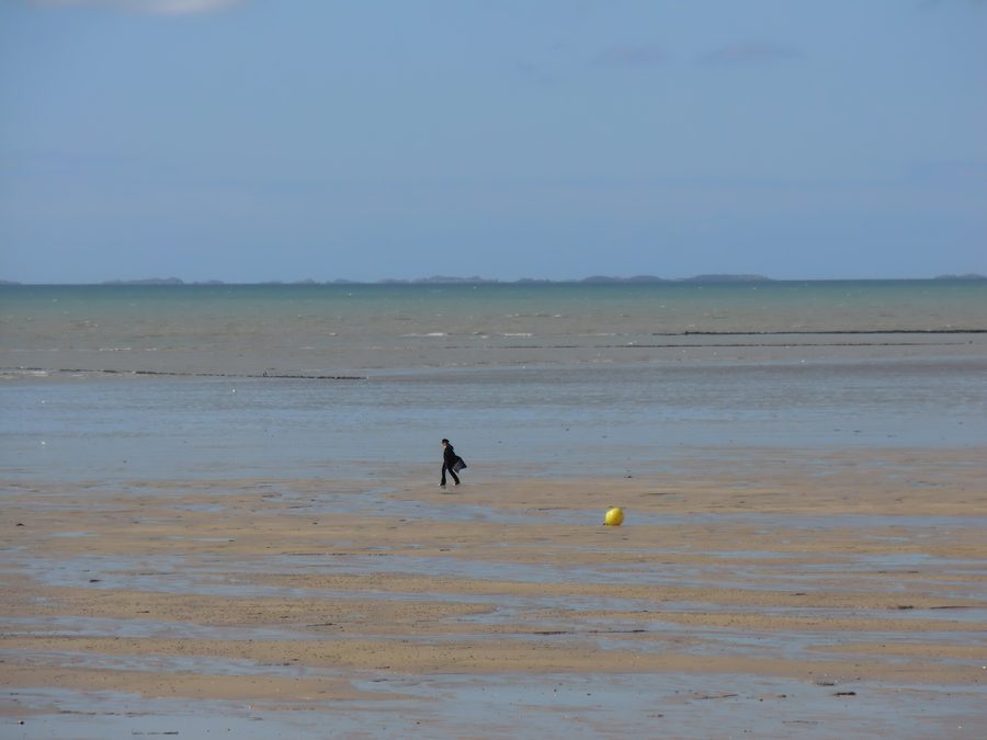 Sandy beach at Jullouville in Normandy with the Chausey Islands in the background
